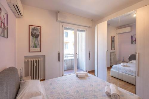 a white room with a bed and a mirror at Borgo House, Bologna by Short Holidays in Bologna