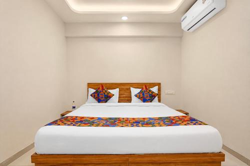 a bedroom with a large white bed in a room at FabHotel SB Palace in Nashik