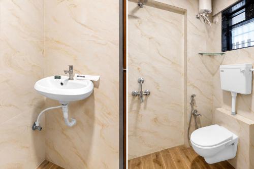 a bathroom with a toilet and a sink and a shower at FabHotel SB Palace in Nashik