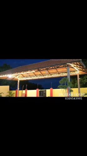 a train station with a platform with a roof at Dn FARM HOUSE in Moinabad