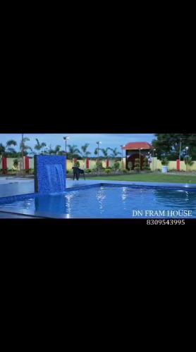 a picture of a swimming pool in a resort at Dn FARM HOUSE in Moinabad