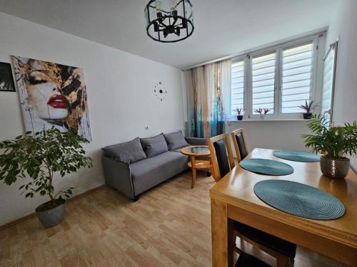 a living room with a couch and a table at Apartament WELES in Bolesławiec