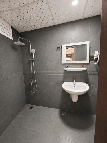 a bathroom with a sink and a shower at Çorlu Aras Hotel & City Center Location in Çorlu