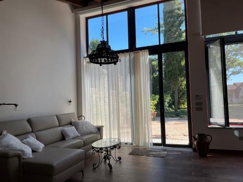 a living room with a couch and a chandelier at Antica serra in Buttrio
