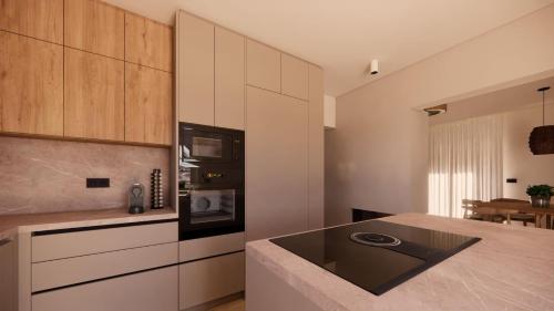 a kitchen with white cabinets and a counter top at Theo's Garden Villa in Kefalos