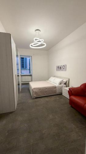 a bedroom with a bed and a red couch at La Casa di Stela 2 in Terni