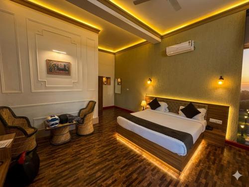 a hotel room with a large bed and a couch at The Vanashva in Tehla