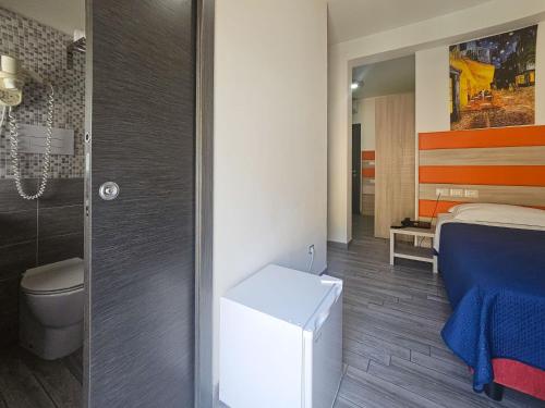 a bathroom with a bed and a shower and a toilet at Hotel Chrismare Taormina in Taormina