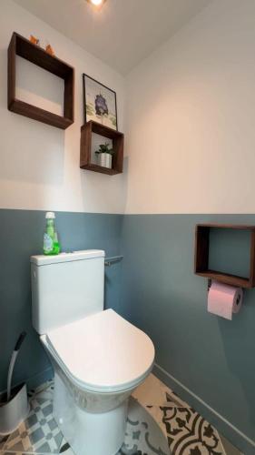 a bathroom with a white toilet in a room at Authentic Breton penty in Penmarch