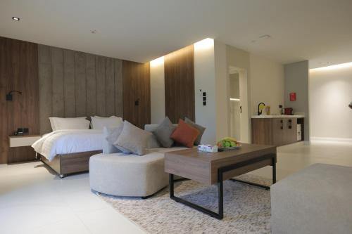 a bedroom with a bed and a couch and a table at شاليهات واجهة الشفا in Taif