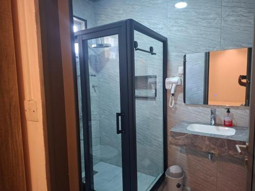 a bathroom with a glass shower and a sink at Blue bay in Blue Bay