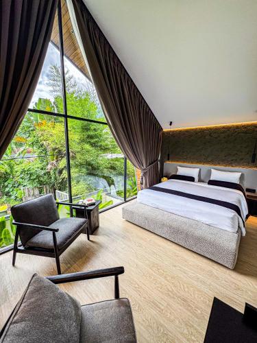a bedroom with a bed and a large window at Superior Luxury Loft with Working Desk, Instagramable Pool in Kerobokan