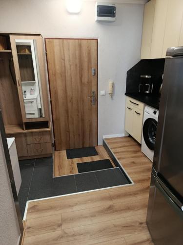 a small kitchen with a door in the middle of it at Apartmán Comfort in Trenčín