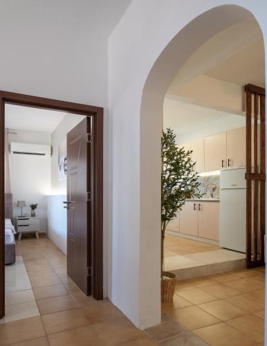 an open door into a kitchen with a tree in it at Silvia's Haus in Neos Marmaras