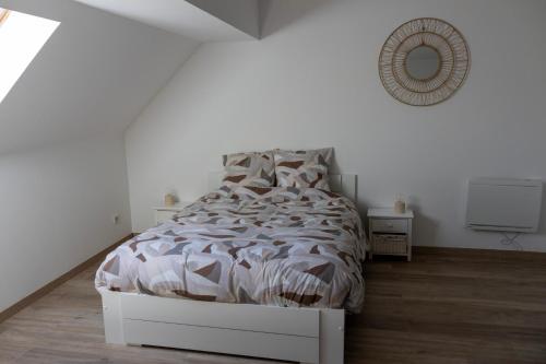 a white bedroom with a bed and a tv at Gîte de la Dheune in Essertenne