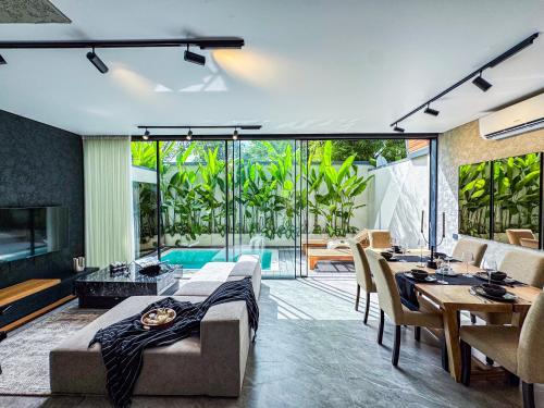 a living room with a couch and a table at Superior Luxury Loft with Working Desk, Instagramable Pool in Kerobokan