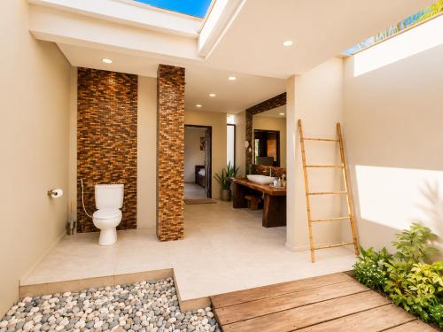 a bathroom with a toilet and a sink at Relax Bali Resort, Diving & SPA, ocean front in Tulamben