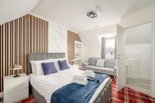 a bedroom with a bed with two towels on it at Bosta Guest House - Private Rooms - Inverness in Inverness