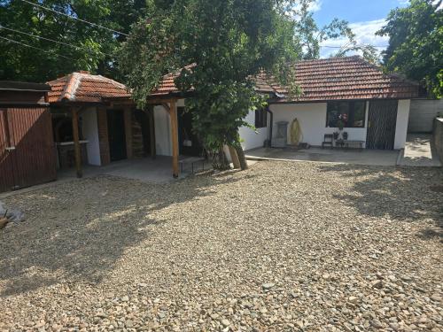 a house with a gravel yard in front of it at Seosko domaćinstvo Trajković in Mladenovac
