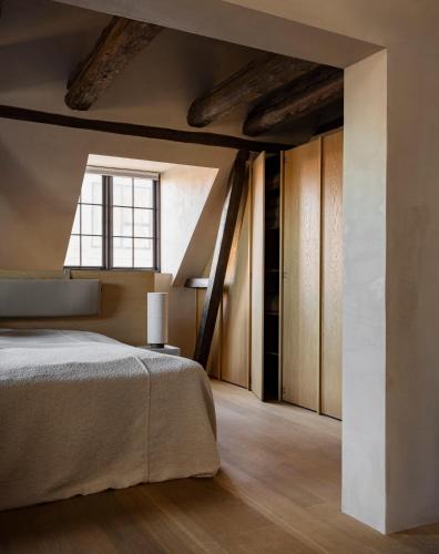 a bedroom with a large bed and a window at Audo Boutique Hotel in Copenhagen