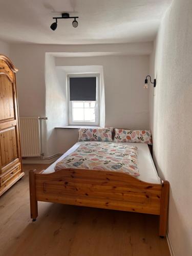 a bedroom with a bed in a room with a window at Ferienhaus Vinzenze in Ediger-Eller