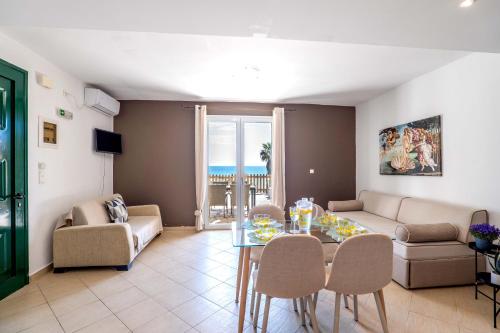 a living room with a table and chairs at Corfu Dream Holidays Villas in Glyfada
