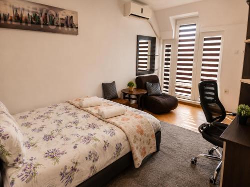 a bedroom with a bed and two chairs in it at Comfortable Room in The City Centre in Varna City