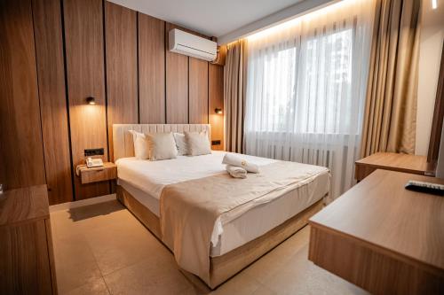 a hotel room with a bed and a window at Hotel Dva Bisera in Ohrid