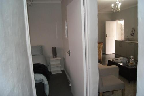 a small room with a bed and a desk in a room at Chalet Steenbok in Ladismith