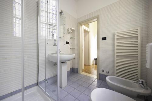 a white bathroom with a sink and a shower at Nel Cuore di Bologna V ,Bologna by Shortholidays in Bologna