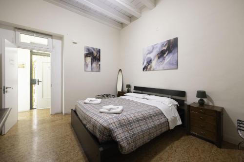 a bedroom with a bed with two towels on it at Nel Cuore di Bologna V ,Bologna by Shortholidays in Bologna