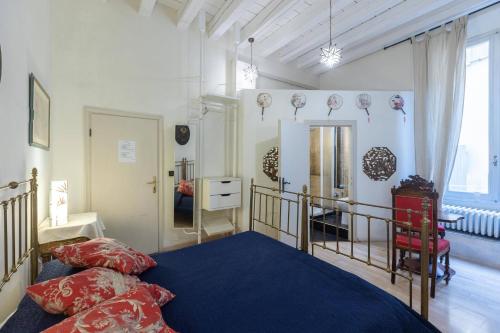 a bedroom with a bed with a blue comforter at Nel Cuore di Bologna M ,Bologna by Shortholidays in Bologna