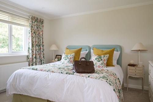 a bedroom with a large bed with a purse on it at Meadow Drive in Bembridge