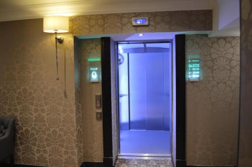 a elevator in a building with a light on the wall at Cruachan Hotel in Fort William