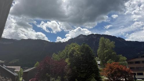 a view of a mountain range with trees and buildings at Mellau Appartments 220 in Mellau