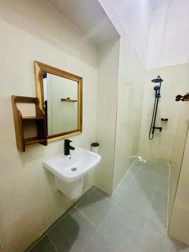 a bathroom with a sink and a mirror at NorArt House in Zanzibar City