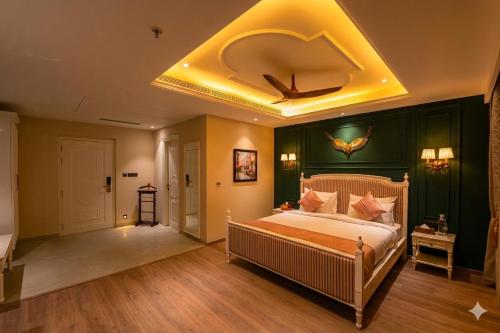 a bedroom with a large bed with a ceiling at The Sunder Palace-Jaipur City Centre Hotel in Jaipur