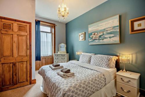 a bedroom with a bed with towels on it at 5 Bed in Tynemouth oc-cn125 in Tynemouth