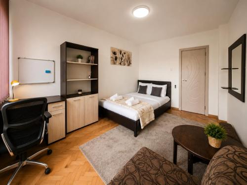 a bedroom with a bed and a tv and a chair at City Centre Room Near Everything in Varna City