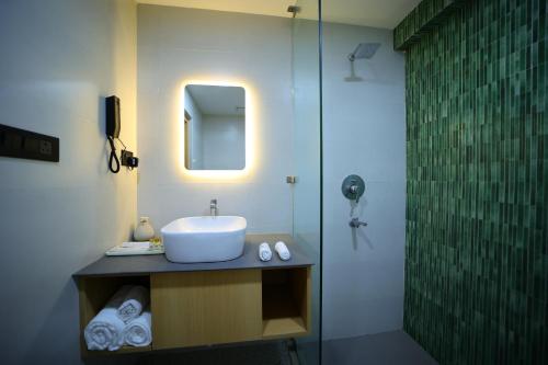 a bathroom with a sink and a shower at Surya Garden in Tālcher