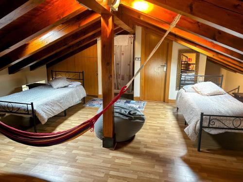 a room with two beds and a hammock in it at La Casa deMercadillo in Liérganes