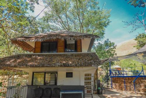 a house with a thatch roof on top of it at Ohana in Coron