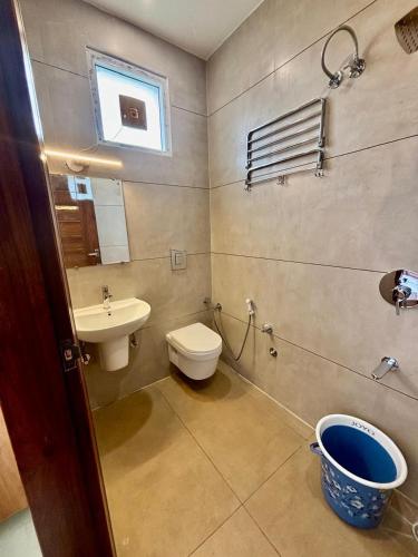 a bathroom with a toilet and a sink at Hotel Channo Residency in Nadāmpur