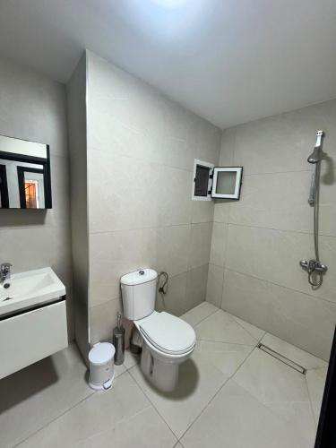a bathroom with a toilet and a sink at Dar l Bihar in Al Hoceïma