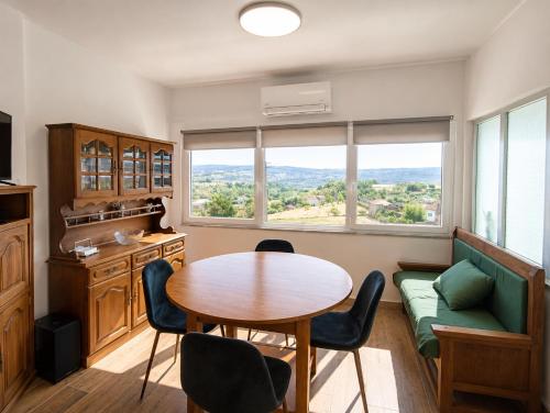 a dining room with a table and chairs and a window at Casa Machado in Vila Real