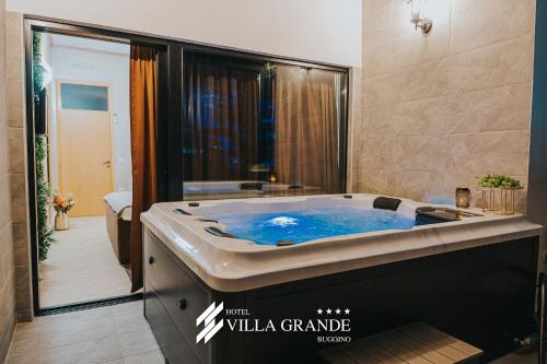 a bathroom with a large blue tub in it at Villa Grande Terrace Jacuzzi Suite in Bugojno