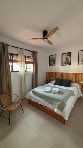 a bedroom with a large bed and a ceiling fan at El Mirador del Asno in El Bosque