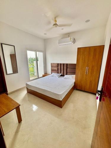 a bedroom with a bed with a wooden headboard at Hotel Channo Residency in Nadāmpur