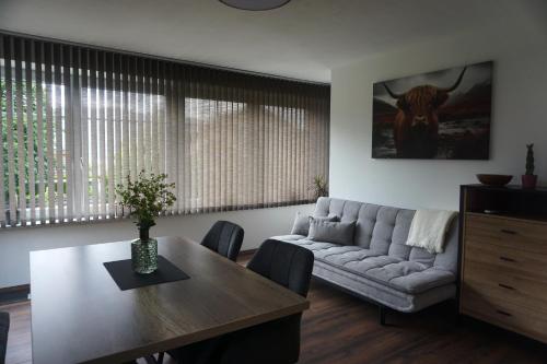 a living room with a couch and a table at Ferienwohnung Heidi in Mariapfarr