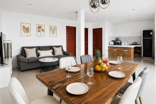 a dining room and living room with a wooden table at Villa Archie INCREDIBLE Sea View second fl in Ko Phangan
